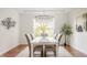 Elegant dining room with a chandelier, a large window, and a modern art piece at 734 Richland Way, Westfield, IN 46074