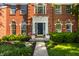 Close-up of the home's front door with lovely landscaping, plants and brick facade at 734 Richland Way, Westfield, IN 46074