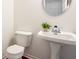 Simple half bathroom featuring a pedestal sink and toilet, perfect for guests at 734 Richland Way, Westfield, IN 46074