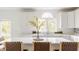 Well-lit kitchen with white cabinets, a large island, quartz countertops, and stylish bar stools at 734 Richland Way, Westfield, IN 46074