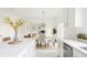 Bright kitchen showcasing an island with seating, open dining area, and views of the fireplace at 734 Richland Way, Westfield, IN 46074