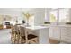 Bright kitchen featuring white cabinets, quartz countertops, an island and stainless appliances at 734 Richland Way, Westfield, IN 46074