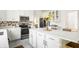 Contemporary kitchen with white cabinets, stainless appliances, and island with bar seating at 734 Richland Way, Westfield, IN 46074