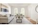 Bright living room featuring large windows, hardwood floors, and comfortable neutral-toned seating at 734 Richland Way, Westfield, IN 46074