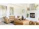 Living room with fireplace, artwork, and comfortable tan leather sofa set at 734 Richland Way, Westfield, IN 46074