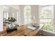 Well-lit office space with a wooden desk, decorative vase and a view to the living room at 734 Richland Way, Westfield, IN 46074