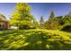Expansive lawn with beautiful trees and landscaping offers plenty of space for outdoor activities at 734 Richland Way, Westfield, IN 46074