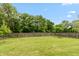 Lush backyard with a well-maintained lawn and mature trees, offering privacy and space at 8084 Lawrence Woods Pl, Indianapolis, IN 46236