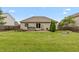 Spacious backyard with a hot tub, patio area, and lush lawn, ideal for outdoor living at 8084 Lawrence Woods Pl, Indianapolis, IN 46236