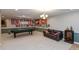 Finished basement with a pool table, leather sofa, and sports-themed decorations, perfect for entertaining guests at 8084 Lawrence Woods Pl, Indianapolis, IN 46236