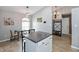 Cozy eat-in kitchen with an island, dining table, and decorative lighting at 8084 Lawrence Woods Pl, Indianapolis, IN 46236