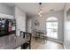 Cozy eat-in kitchen with an island, dining table, and decorative lighting at 8084 Lawrence Woods Pl, Indianapolis, IN 46236