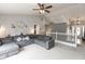 Cozy living room featuring vaulted ceilings, a large gray sofa, and neutral decor at 8084 Lawrence Woods Pl, Indianapolis, IN 46236