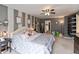Spacious main bedroom offering carpeted floors, ceiling fan, and decorative wall decor for a relaxing atmosphere at 8084 Lawrence Woods Pl, Indianapolis, IN 46236