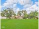 Expansive backyard featuring mature trees and an outdoor patio with gazebo at 8102 Sycamore Springs Trl, Indianapolis, IN 46239