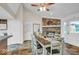Open concept dining room with a stone fireplace and natural light throughout at 8102 Sycamore Springs Trl, Indianapolis, IN 46239