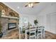 Cozy dining room with a stone fireplace, ceiling fan and white wood table at 8102 Sycamore Springs Trl, Indianapolis, IN 46239
