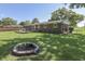 Backyard featuring a well-maintained lawn and a charming fire pit surrounded by lush greenery at 8246 S Franklin Rd, Indianapolis, IN 46259
