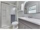 Updated bathroom with a glass shower, modern vanity, and an oval mirror at 8246 S Franklin Rd, Indianapolis, IN 46259