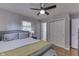 Comfortable bedroom with a gray upholstered headboard, closet, and hardwood floors at 8246 S Franklin Rd, Indianapolis, IN 46259