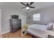 Cozy bedroom with a ceiling fan, hardwood floors, and a large dresser and closet at 8246 S Franklin Rd, Indianapolis, IN 46259
