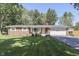 Charming brick ranch home with attached garage, beautiful lawn and mature trees at 8246 S Franklin Rd, Indianapolis, IN 46259