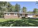 Lovely brick ranch with a well-maintained front lawn, attached garage, and charming front porch at 8246 S Franklin Rd, Indianapolis, IN 46259