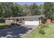 Beautiful single-story brick home featuring an attached garage, driveway, and lush green lawn at 8246 S Franklin Rd, Indianapolis, IN 46259