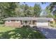 Charming brick ranch-style home with an attached garage, landscaped yard, and mature trees at 8246 S Franklin Rd, Indianapolis, IN 46259