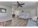 Bright living room with wood-look flooring and a ceiling fan overlooking the dining area at 8246 S Franklin Rd, Indianapolis, IN 46259