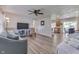 Open-concept living room featuring wood-look floors, shiplap accent wall and a ceiling fan at 8246 S Franklin Rd, Indianapolis, IN 46259