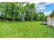A view of the expansive backyard and the back of the house on a sunny day at 9002 Walton St, Indianapolis, IN 46231