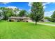 Lovely home with mature landscaping, manicured lawn, and a long driveway at 9002 Walton St, Indianapolis, IN 46231