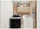 This functional laundry room has a washer, dryer, cabinets, and storage shelves at 9002 Walton St, Indianapolis, IN 46231