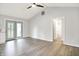Open-concept living room with vaulted ceilings, wood-look floors, and access to a bathroom at 9002 Walton St, Indianapolis, IN 46231