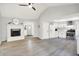 Cozy living space with a fireplace that flows into the kitchen with white cabinetry at 9002 Walton St, Indianapolis, IN 46231