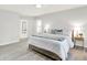 Beautifully staged main bedroom featuring a comfortable king bed and natural light from a large window at 9002 Walton St, Indianapolis, IN 46231