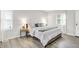 Beautifully staged main bedroom featuring a comfortable king bed and natural light from two large windows at 9002 Walton St, Indianapolis, IN 46231