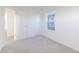 Bright bedroom featuring neutral carpet, two doors, and a large window at 9136 Anthem Ave, Plainfield, IN 46168