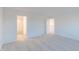 Bright bedroom featuring neutral carpet, two doors, and open layout at 9136 Anthem Ave, Plainfield, IN 46168