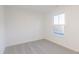 Bright bedroom features neutral carpet, white walls, and natural light from the window at 9136 Anthem Ave, Plainfield, IN 46168