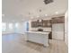 Bright kitchen with an island, stainless appliances, and hardwood floors open to the living space at 9136 Anthem Ave, Plainfield, IN 46168