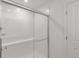 Glass-enclosed shower with tiled walls, bench, and modern fixtures at 9136 Anthem Ave, Plainfield, IN 46168