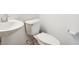 Small white bathroom features a pedestal sink, toilet, and chrome fixtures at 9160 Anthem Ave, Plainfield, IN 46168