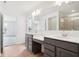 Bathroom featuring a double vanity, grey cabinets, wood-look floors and a large mirror at 9160 Anthem Ave, Plainfield, IN 46168