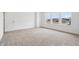An empty bedroom with neutral carpet, three windows and white walls and trim at 9160 Anthem Ave, Plainfield, IN 46168
