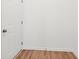 This empty room features light wood vinyl floors, white walls and a white door at 9160 Anthem Ave, Plainfield, IN 46168