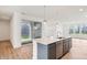 Kitchen with gray cabinets, stainless steel appliances, and sliding door access to the patio at 9160 Anthem Ave, Plainfield, IN 46168