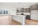 Stylish kitchen with gray cabinets, stainless steel appliances and a large island at 9160 Anthem Ave, Plainfield, IN 46168