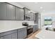 Updated kitchen features gray cabinets, stainless steel appliances, and quartz countertops at 9160 Anthem Ave, Plainfield, IN 46168